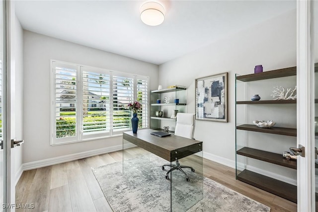 office area featuring light hardwood / wood-style floors and french doors