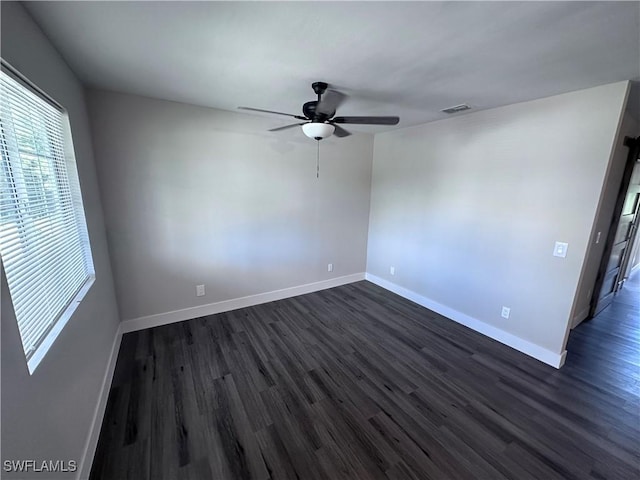 spare room featuring ceiling fan and dark wood-type flooring