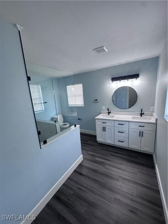 bathroom with vanity, a shower, and wood-type flooring