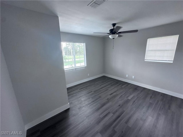 spare room with ceiling fan and dark wood-type flooring