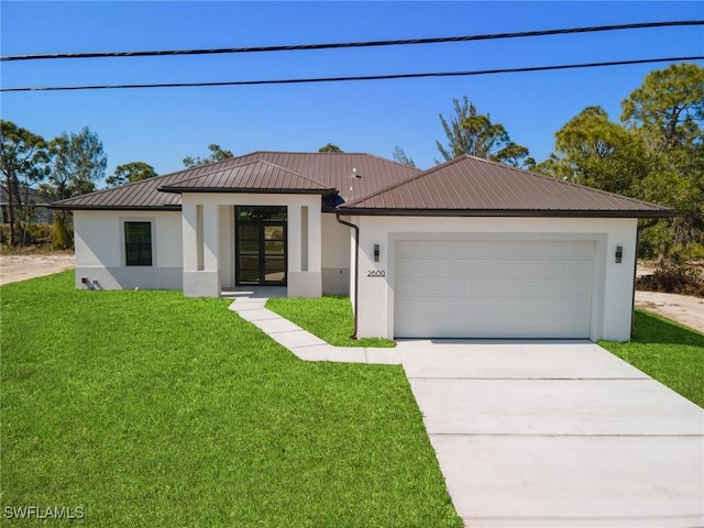 view of front of property featuring a garage and a front lawn