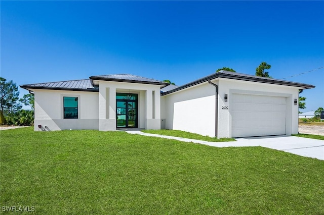 view of front of property with a garage and a front lawn