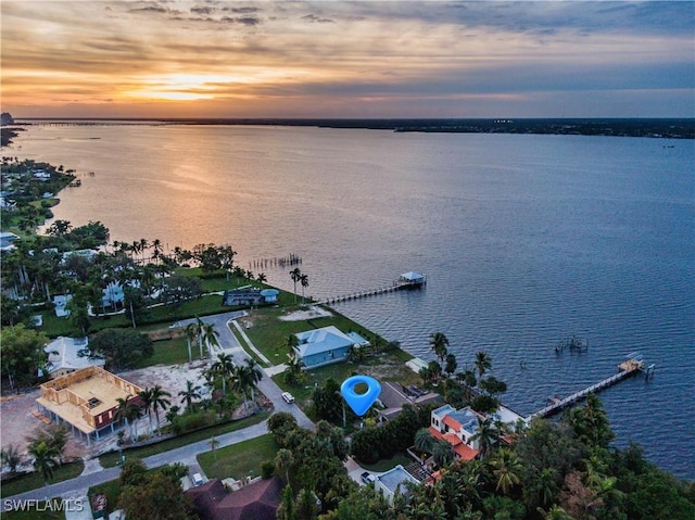 aerial view at dusk with a water view