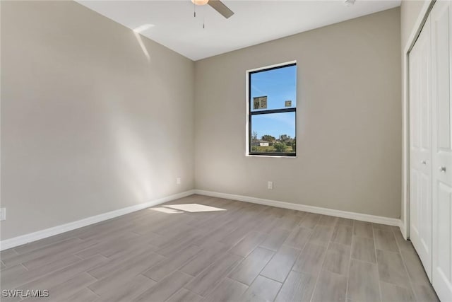 unfurnished bedroom featuring ceiling fan, a closet, and light hardwood / wood-style flooring