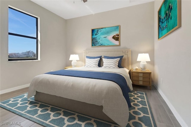 bedroom with ceiling fan and wood-type flooring