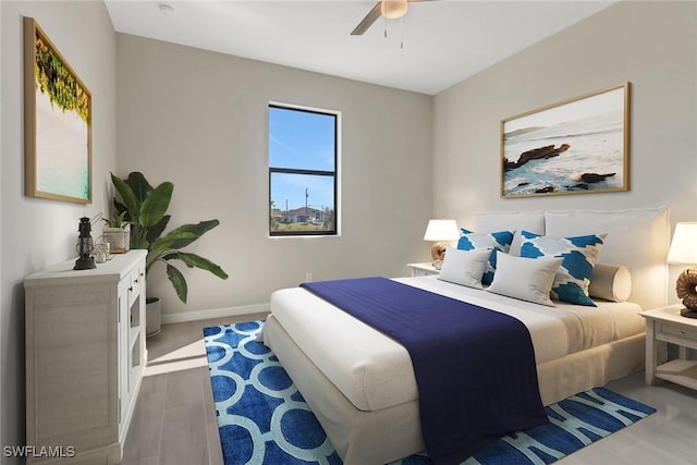 bedroom with wood-type flooring and ceiling fan