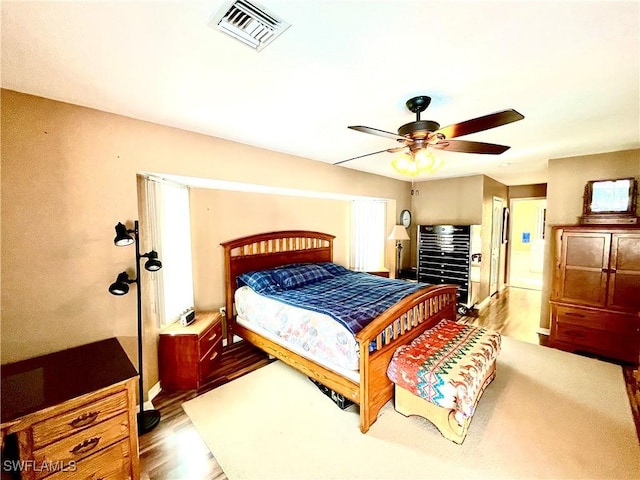 bedroom featuring ceiling fan and light hardwood / wood-style flooring