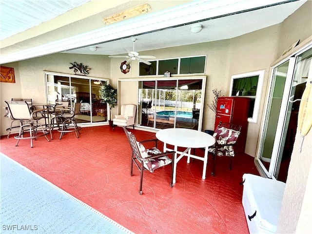 sunroom / solarium featuring ceiling fan