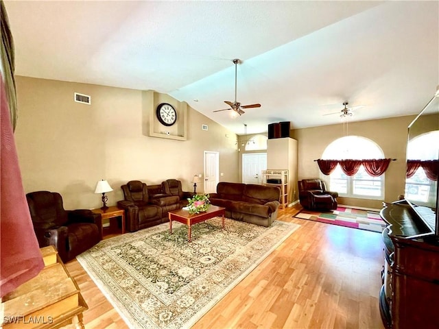 living room featuring hardwood / wood-style flooring, ceiling fan, and lofted ceiling