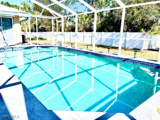 view of pool featuring glass enclosure