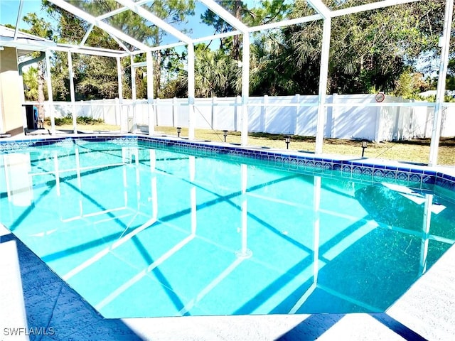 view of swimming pool with glass enclosure