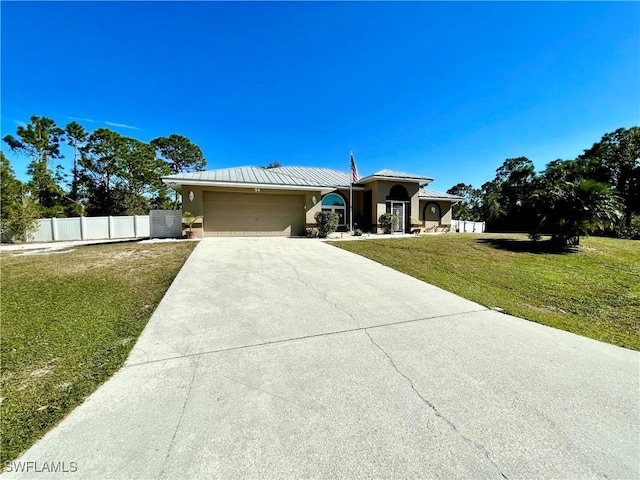 view of front of house featuring a front yard and a garage