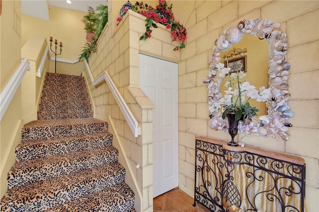 stairs with tile patterned floors