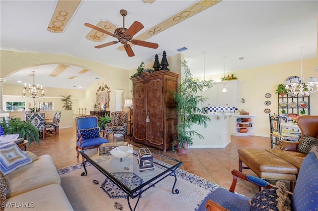 living room with light tile patterned floors, visible vents, arched walkways, and ceiling fan with notable chandelier