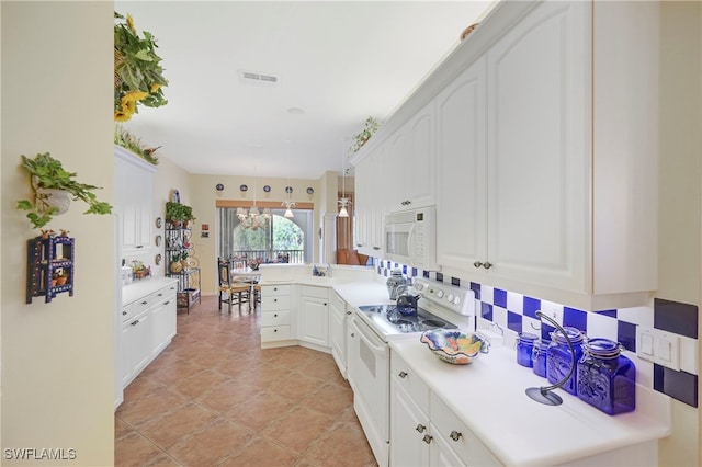 10801 Crooked River Rd Unit 203, Estero, FL 34135 - kitchen with hanging light fixtures, white appliances, light countertops, and white cabinetry