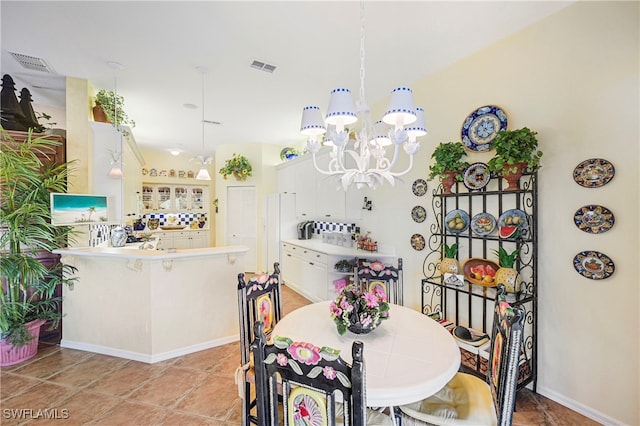 10801 Crooked River Rd Unit 203, Estero, FL 34135 - dining room featuring an inviting chandelier, baseboards, and visible vents