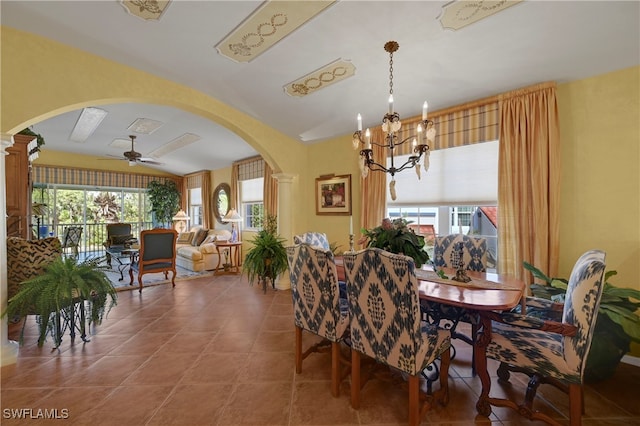 10801 Crooked River Rd Unit 203, Estero, FL 34135 - tiled dining room featuring arched walkways, plenty of natural light, and ceiling fan with notable chandelier