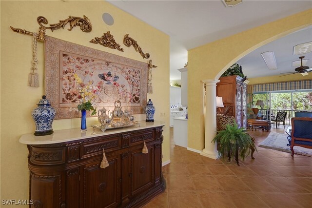 10801 Crooked River Rd Unit 203, Estero, FL 34135 - corridor with light tile patterned floors, baseboards, decorative columns, and arched walkways