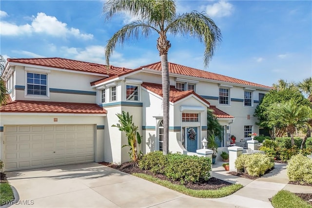 10801 Crooked River Rd Unit 203, Estero, FL 34135 - mediterranean / spanish-style home featuring a tiled roof, driveway, and stucco siding