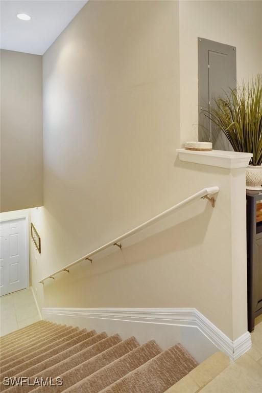 stairway featuring tile patterned flooring