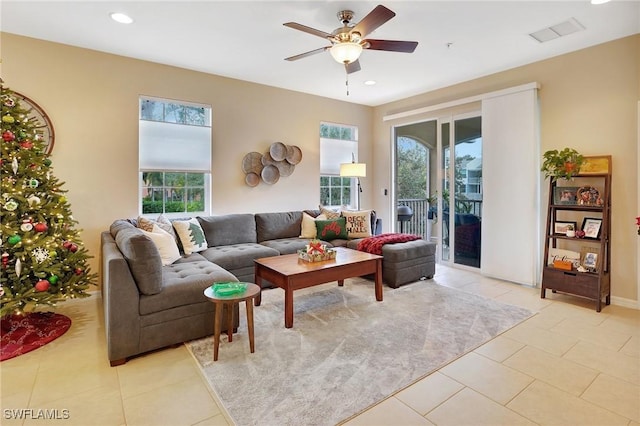 tiled living room featuring ceiling fan