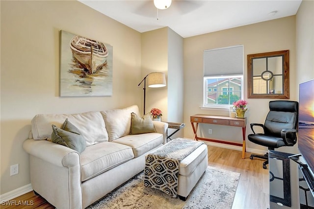 living room with hardwood / wood-style floors and ceiling fan