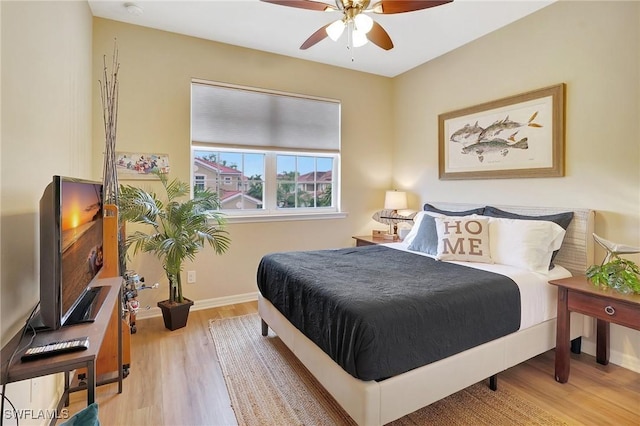 bedroom with hardwood / wood-style floors and ceiling fan