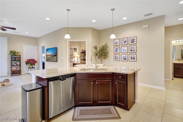 kitchen featuring dishwasher, hanging light fixtures, a center island with sink, and sink