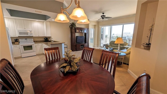 dining room with ceiling fan, sink, light tile patterned floors, and ornamental molding