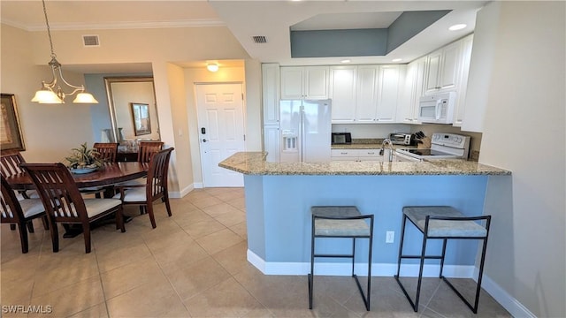 kitchen with kitchen peninsula, white appliances, white cabinetry, and a notable chandelier