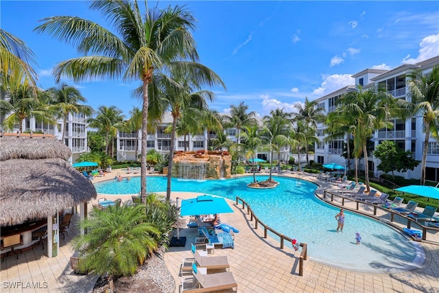 view of swimming pool featuring pool water feature and a patio area