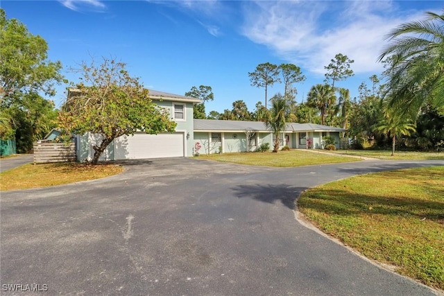 view of front of property featuring a front yard and a garage