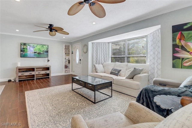 living room featuring ceiling fan, dark hardwood / wood-style flooring, and ornamental molding