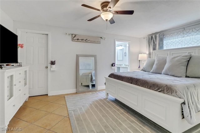 tiled bedroom featuring ensuite bathroom and ceiling fan