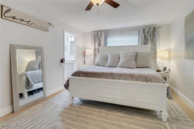 bedroom with ensuite bathroom and ceiling fan