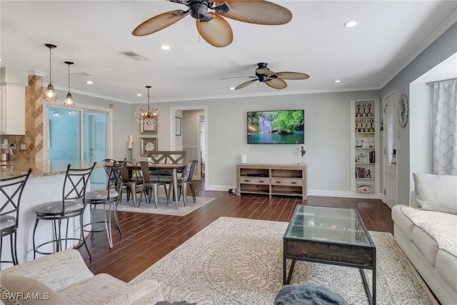 living room featuring crown molding, dark hardwood / wood-style flooring, and ceiling fan with notable chandelier