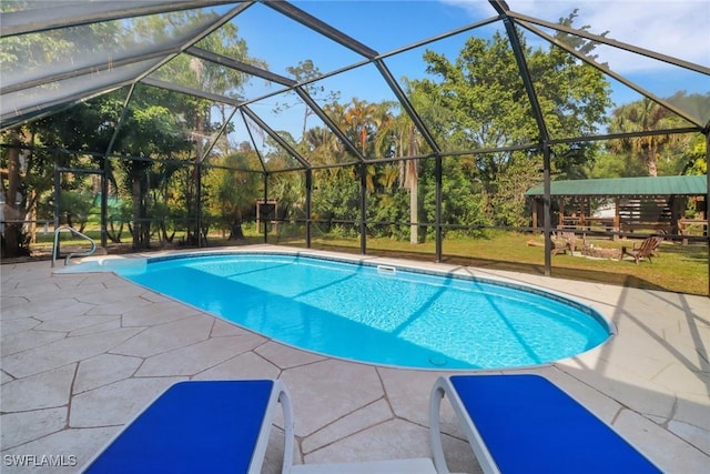 view of swimming pool featuring glass enclosure and a patio area