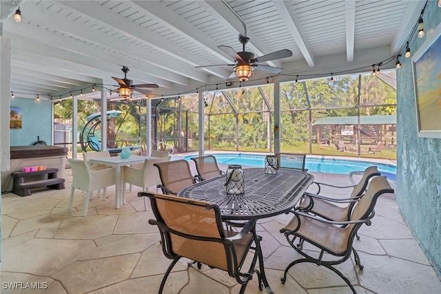 view of patio featuring ceiling fan and glass enclosure