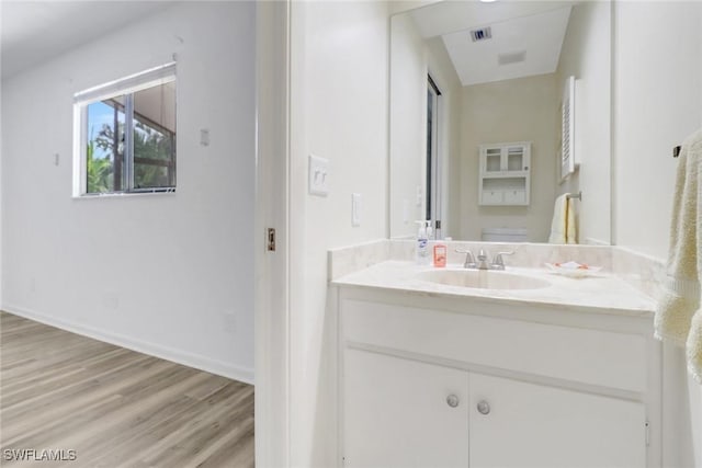 bathroom with hardwood / wood-style floors and vanity