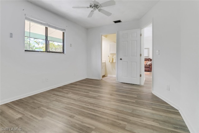 spare room featuring ceiling fan and light wood-type flooring