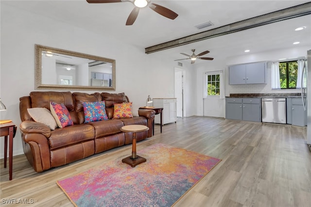 living room with beamed ceiling and light hardwood / wood-style floors