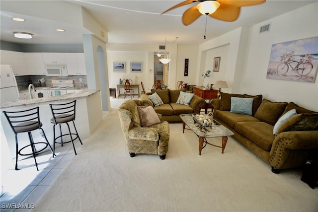 living room featuring light tile patterned floors and ceiling fan