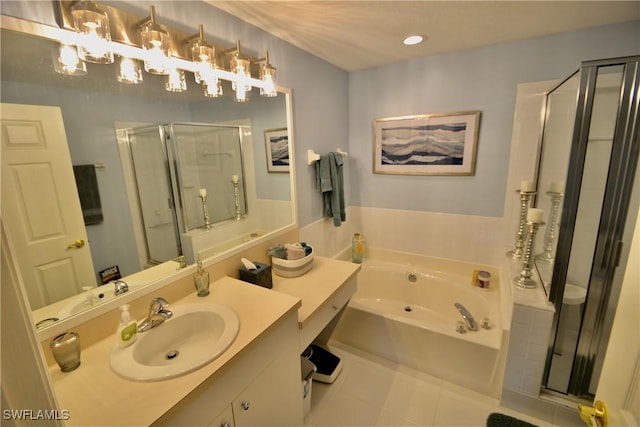 bathroom featuring plus walk in shower, vanity, and tile patterned floors