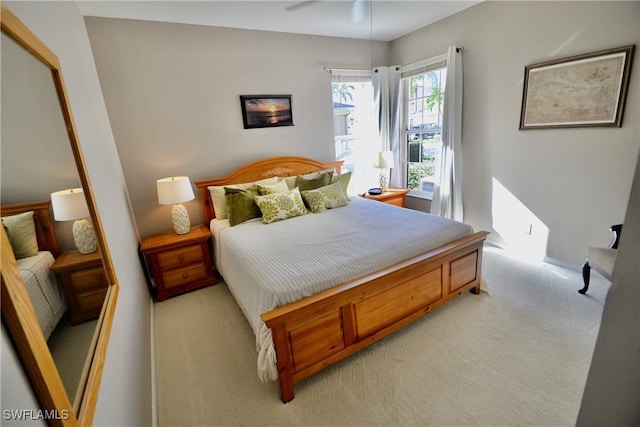 bedroom with ceiling fan and light colored carpet