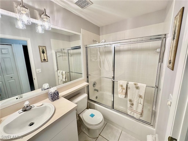 full bathroom featuring tile patterned flooring, vanity, toilet, and enclosed tub / shower combo