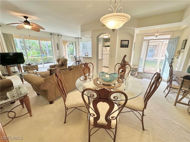 carpeted dining room featuring ceiling fan