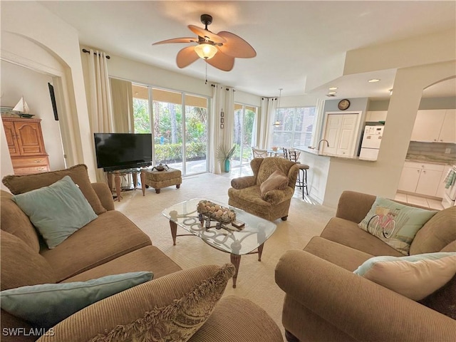 carpeted living room featuring ceiling fan