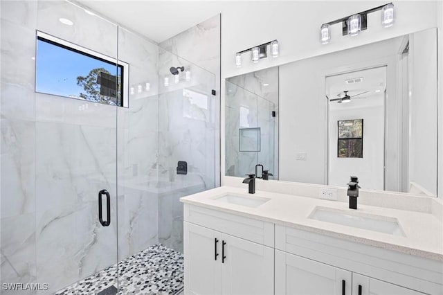 bathroom with walk in shower, ceiling fan, and a healthy amount of sunlight