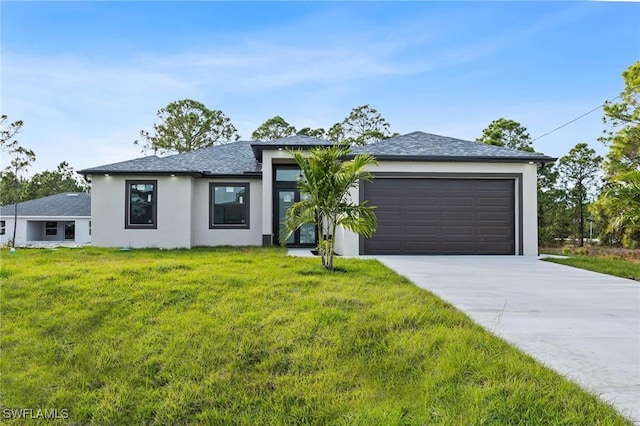 view of front of house featuring a garage and a front lawn