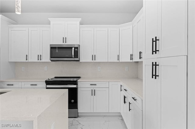 kitchen with white cabinetry and appliances with stainless steel finishes